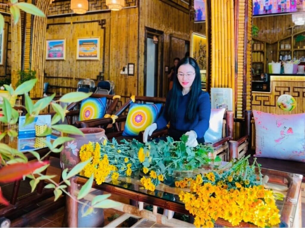 Chị Thủy Vĩnh Phúc tự tay cắm hoa tại quán Tinh Hoa, duy trì không gian phục vụ gọn gàng và gần gũi với khách hàng.